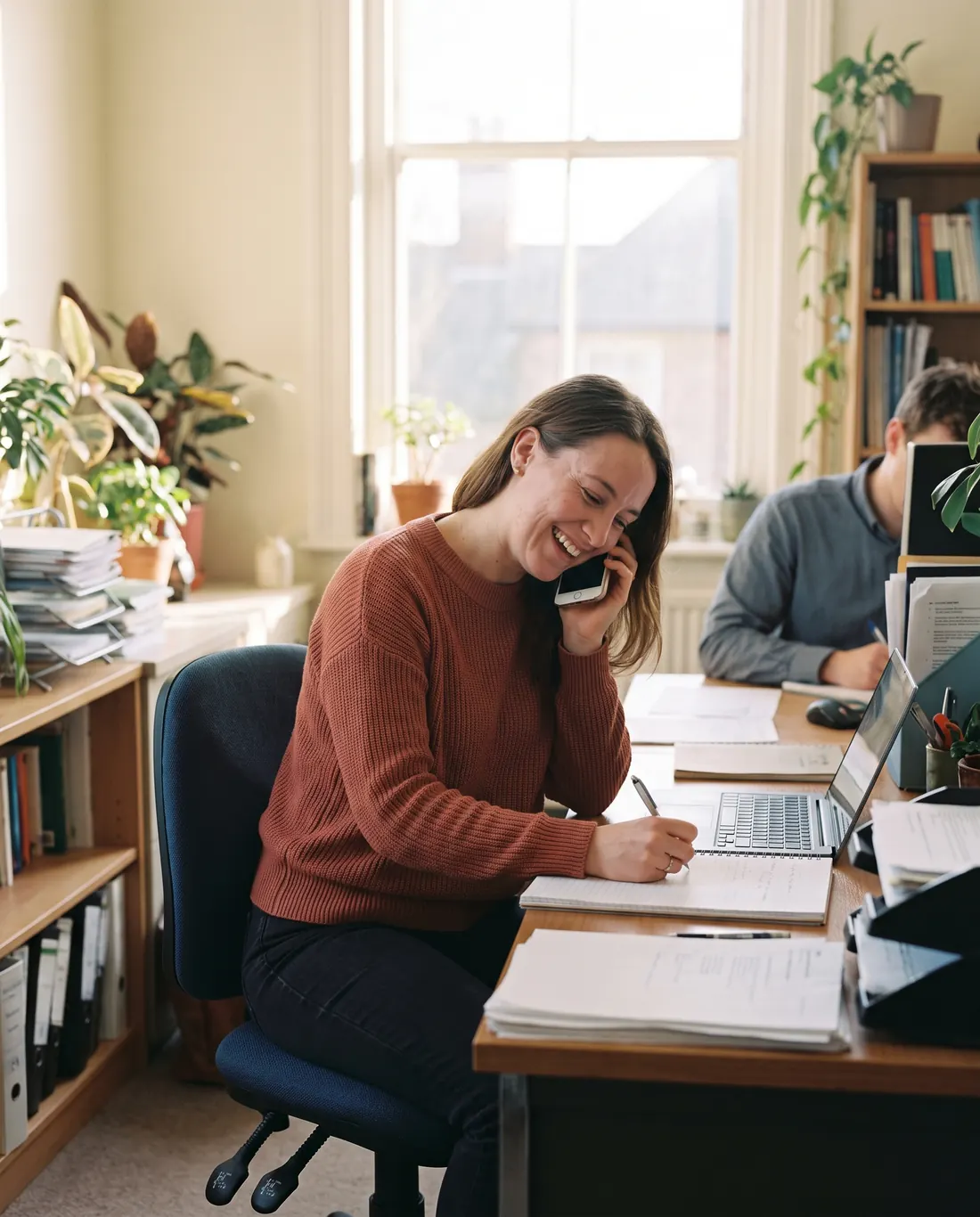 A recruiter on a phone call taking notes